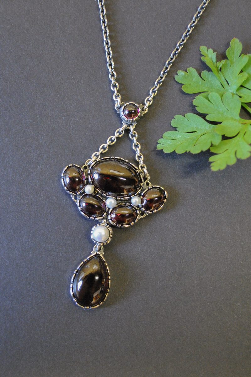 Trachtenschmuck Granatschmuck: Moderne Trachtenkette in Silber mit Granat und Perlen gefasst