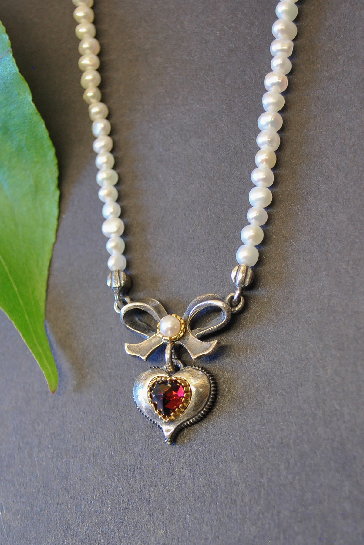 Perlenkette von Seite mit Schleife und Herz
